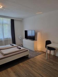 a bedroom with a bed and a flat screen tv at Süße Marie 10 in Karlsruhe +8 photos