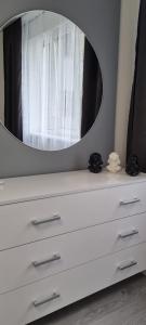 a white dresser with a mirror on top of it at Панорама Апарт готель in Ternopil