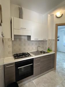 a kitchen with a sink and a stove top oven at Appartament Tea in Šorići