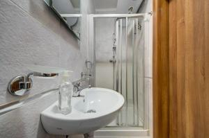 a bathroom with a white sink and a shower at Central, spacious apartment with Sea Views in St. Paul's Bay +15 photos