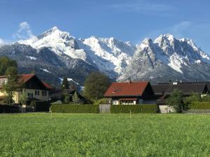 a view of snow covered mountains from a house at Red Fox Apartment in Garmisch-Partenkirchen