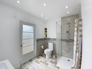 a bathroom with a toilet and a shower at Cozy Alclau in Mimizan