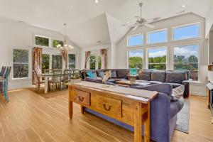 a living room with a couch and a table at 2070 - Sol Mates in Duck
