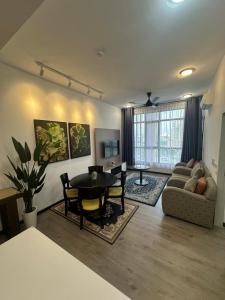 a living room with a table and a couch at Putrajaya Antara Residence, Near PICC, Presint 5 in Putrajaya