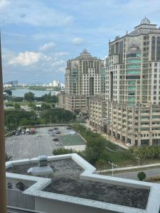 a view of a city with tall buildings and a parking lot at Putrajaya Antara Residence, Near PICC, Presint 5 in Putrajaya