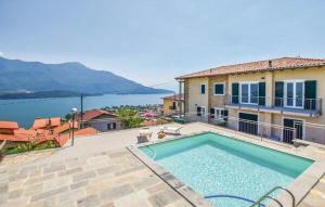a house with a swimming pool in front of the water at Casa bella vista Emma lago Como in Vercana
