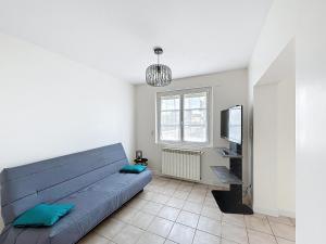 a bedroom with a blue bed and a television at Cozy Alclau in Mimizan +4 photos
