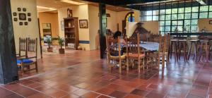 a girl sitting at a table in a restaurant at Posada El Remolino in Anolaima