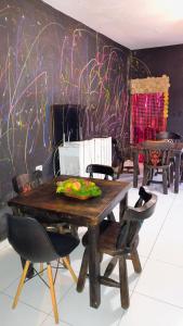a dining room with a wooden table and chairs at San House TEN in Zipaquirá