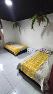 two beds sitting in a room with at San House TEN in Zipaquirá