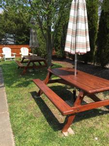 a picnic table with an umbrella on top of it at First floor, 2 bedrm 2 bath, sleeps 6, Parking available, walk to Beach & Shop in Cape May