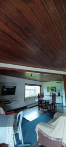 a living room with a table and chairs in a boat at Espaço Casa Cult in Serra
