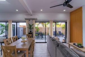 a living room with a table and a couch at Modern House, Rooftop Ocean Views & Private Pool in El Centenario +26 photos