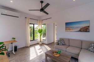 a living room with a couch and a table at Modern House, Rooftop Ocean Views & Private Pool in El Centenario