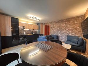 a living room with a table and chairs and a kitchen at Alpine Mood - Vue - Balcon - Parking in Uvernet