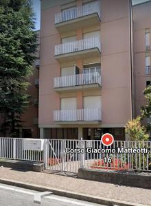 a white fence in front of a building at Casa Corso Matteotti 16 in Lecco
