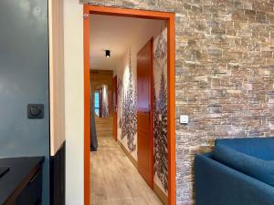 a hallway of a house with a brick wall at Alpine Mood - Vue - Balcon - Parking in Uvernet