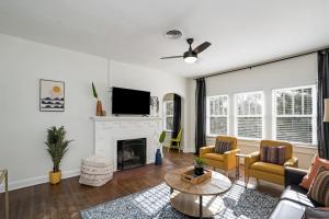 a living room with a couch and a fireplace at Colorful waterside home in Bradenton