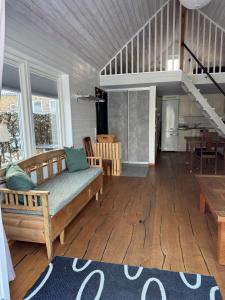 a living room with a couch and a table at Fiskarstugan i Norra Häljaröd in Norra Häljaröd