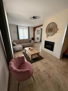 a living room with a couch and a chair and a table at Maison des 3 lacs in Chavanges