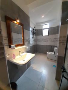 a bathroom with a sink and a toilet at Hiri Dudes Villa in Dickwella