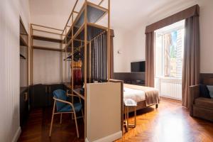 a bedroom with a bed and a desk and a chair at Vittoriano Suite in Rome