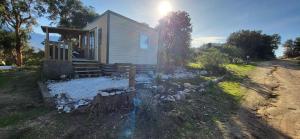 a tiny house with a yard of rocks at Bungalow le Sartène in Lumio