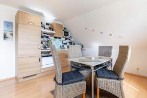 a kitchen with a dining room table and chairs at Ferienwohnung Sterntaler in Goldbeck +12 photos