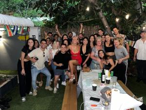 a group of people posing for a picture at a party at OQP Hostel Miami in Miami