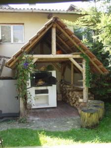 a house with a oven with a roof at Pension Deifel in Daisendorf