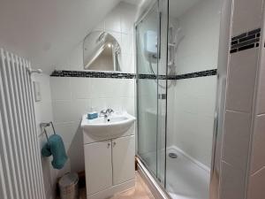a white bathroom with a sink and a shower at Millbrook House Apartments 10 in Milton
