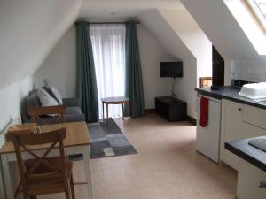 a kitchen and living room with a table and chairs at Millbrook House Apartments 10 in Milton