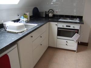 a kitchen with a sink and a counter top at Millbrook House Apartments 10 in Milton