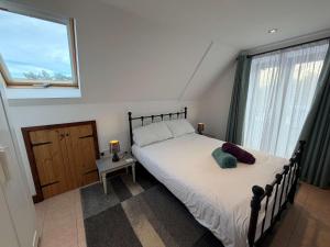 a bedroom with a large bed and a window at Millbrook House Apartments 10 in Milton +13 photos