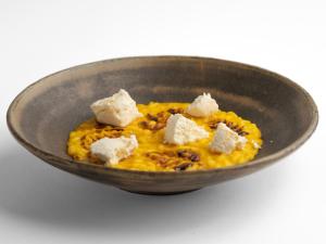 a bowl of food with cubes of cheese on top at Casa Martina in Zogno