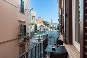 a balcony with a table and a view of a canal at Vittoriano Suite in Rome