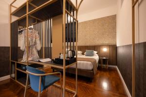 a hotel room with a bed and a mirror at Vittoriano Suite in Rome