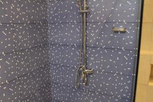 a blue tiled wall with a pair of scissors at Green cottage Ella in Ella +66 photos
