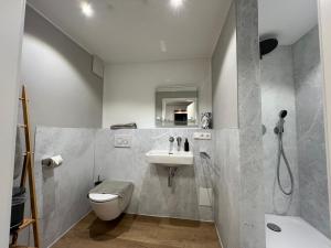 a bathroom with a sink and a toilet and a mirror at Haus Luise in Bad Hindelang