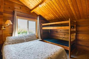 a bedroom with a bunk bed and a window at La Conner Camping Resort Cabin 7 in La Conner