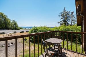 a wooden deck with a table and chairs on it at La Conner Camping Resort Cabin 7 in La Conner +10 photos