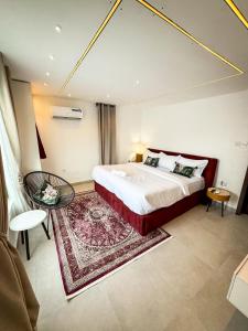 a bedroom with a large bed and a table at MAISON 9 Apartments Surulere in Lagos