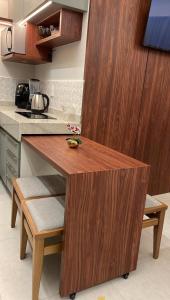 a kitchen with a wooden island in the middle at Flat 02 Residencial ibiapaba in Camocim +3 photos