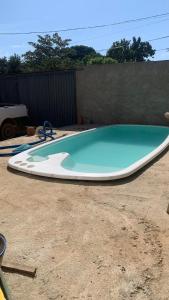 a large swimming pool sitting in a yard at Casa aconchegante com piscina e garagem dupla in Búzios +5 photos