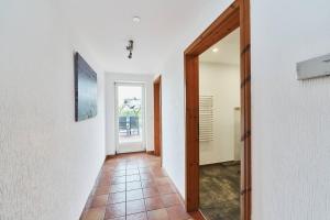 a hallway with a door and a tile floor at Wietblick in Ockholm +17 photos