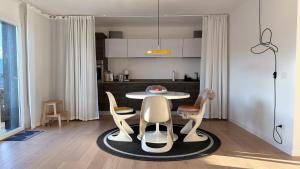 a kitchen with a table and chairs in a room at See- & Bergblick Millstatt in Millstatt