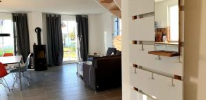 a living room with a couch and a table at Reethaus "Alinde" in Zierow