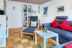 a living room with a couch and two chairs and a table at Bungalow Nixe in Tarnewitz