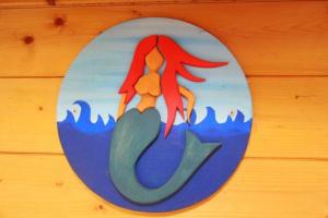 a painting of a mermaid on a wall at Bungalow Nixe in Tarnewitz