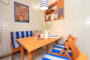 a dining room with a wooden table and chairs at Bungalow Nixe in Tarnewitz +16 photos